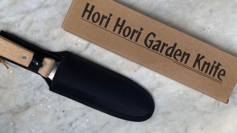 Hori Hori Garden Knife flat lay on an antique marble seat